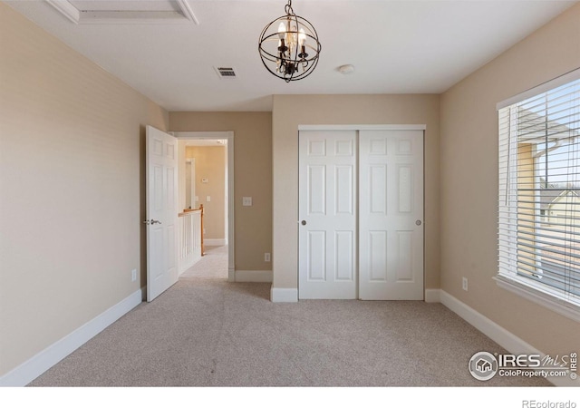 3530 Willow Rd, Frederick, CO 80504 - unfurnished bedroom with visible vents, a closet, baseboards, a chandelier, and carpet flooring