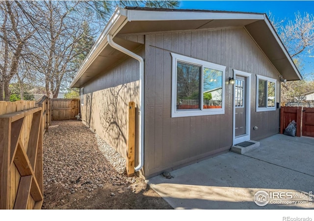 view of side of property with a fenced backyard and a patio area
