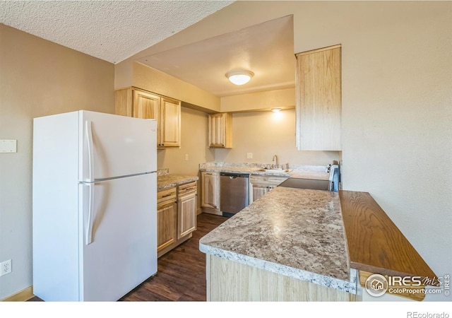 kitchen featuring stainless steel dishwasher, freestanding refrigerator, light brown cabinetry, dark wood-style floors, and light countertops