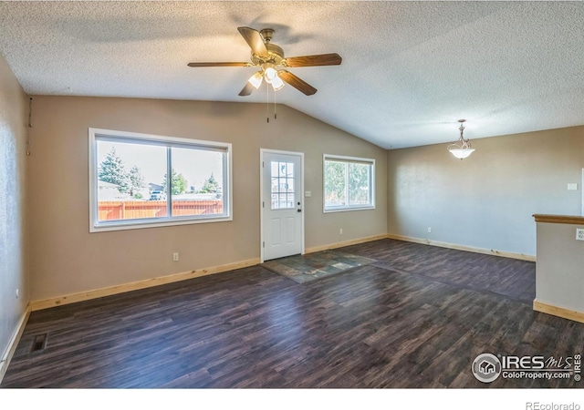 interior space with baseboards, a ceiling fan, dark wood-style flooring, and vaulted ceiling