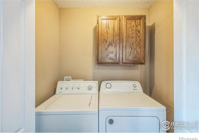 laundry area featuring cabinet space and washer and clothes dryer