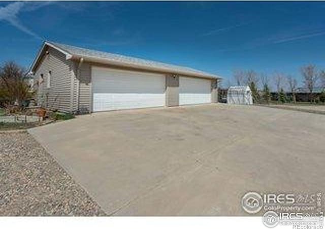 view of property exterior with an outbuilding and a detached garage