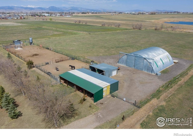 birds eye view of property with a mountain view and a rural view