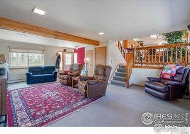carpeted living area with stairway