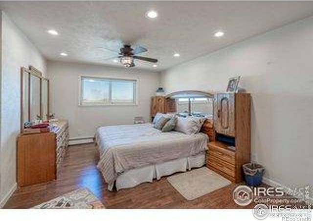 bedroom with recessed lighting, a baseboard heating unit, baseboards, ceiling fan, and wood finished floors