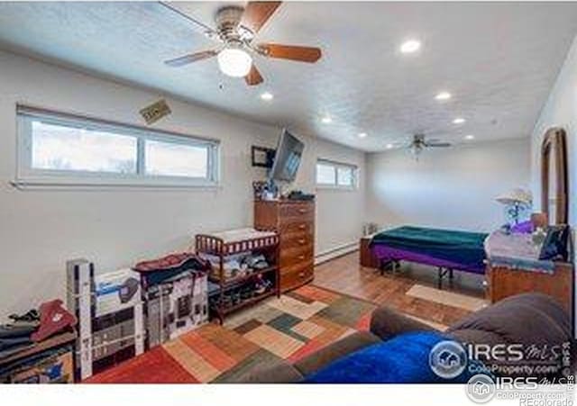 bedroom with recessed lighting and wood finished floors