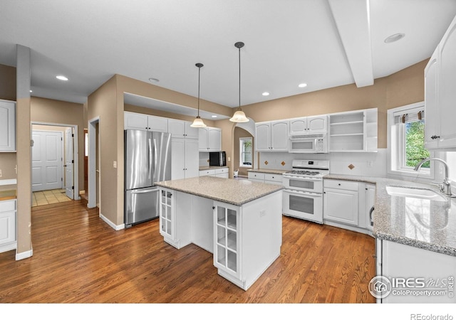 2275 Schooner St, Lafayette, CO 80026 - kitchen with white cabinets, open shelves, light stone counters, a sink, and white appliances