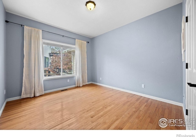 2275 Schooner St, Lafayette, CO 80026 - spare room featuring visible vents, baseboards, and wood finished floors