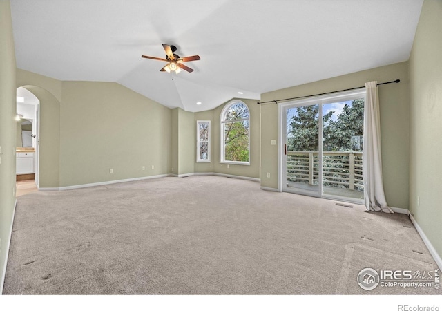 2275 Schooner St, Lafayette, CO 80026 - carpeted empty room with a ceiling fan, visible vents, arched walkways, baseboards, and lofted ceiling