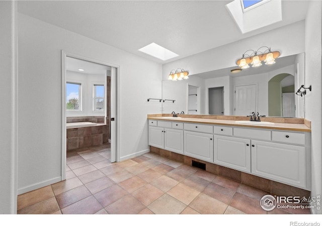 2275 Schooner St, Lafayette, CO 80026 - full bath with baseboards, double vanity, a skylight, and a sink