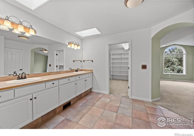 2275 Schooner St, Lafayette, CO 80026 - full bath with a sink, a skylight, double vanity, and visible vents