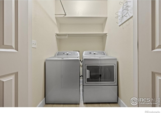 2275 Schooner St, Lafayette, CO 80026 - clothes washing area with baseboards, laundry area, and independent washer and dryer