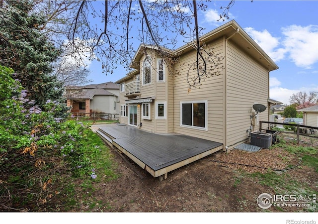 2275 Schooner St, Lafayette, CO 80026 - back of property featuring central AC unit, fence, and a deck