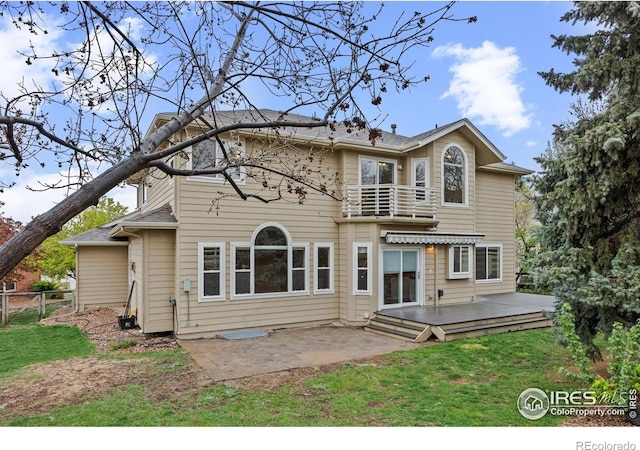 2275 Schooner St, Lafayette, CO 80026 - rear view of property with fence, a lawn, a patio area, and a balcony