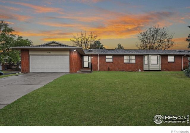 1183 38th Ave, Greeley, CO 80634 - single story home featuring a front yard, a garage, driveway, and brick siding