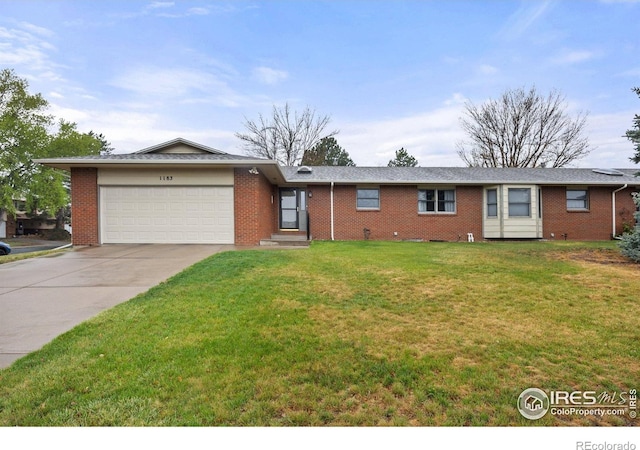 1183 38th Ave, Greeley, CO 80634 - single story home featuring an attached garage, concrete driveway, a front yard, and brick siding