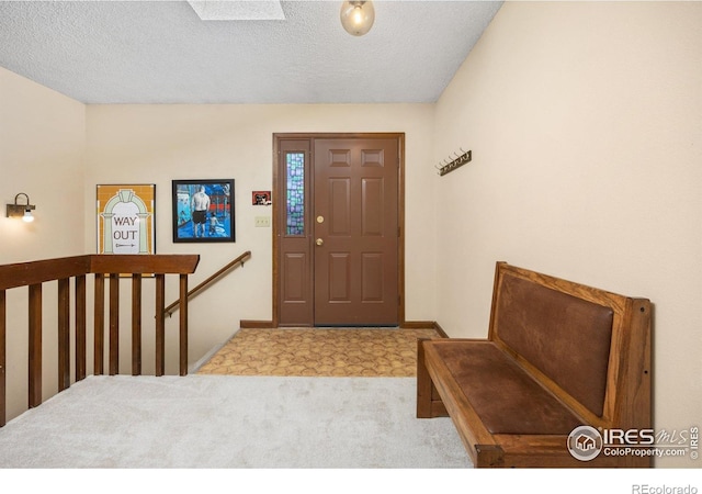 1183 38th Ave, Greeley, CO 80634 - foyer entrance featuring carpet floors and a textured ceiling