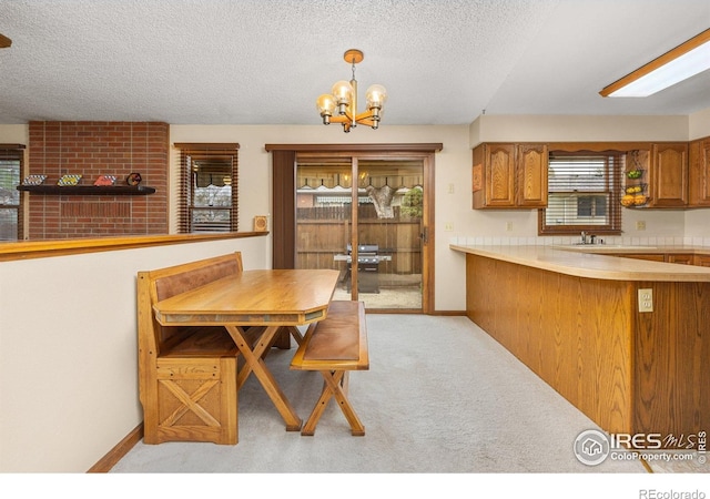 1183 38th Ave, Greeley, CO 80634 - dining area featuring light carpet, a chandelier, and a textured ceiling