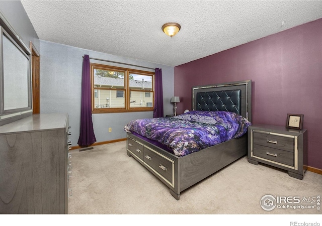 1183 38th Ave, Greeley, CO 80634 - bedroom featuring light colored carpet and a textured ceiling