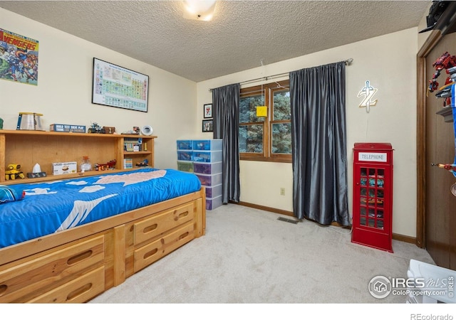 1183 38th Ave, Greeley, CO 80634 - bedroom with light carpet and a textured ceiling
