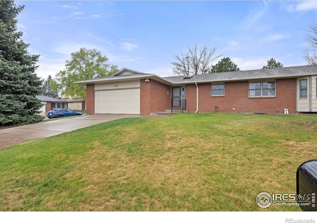 1183 38th Ave, Greeley, CO 80634 - ranch-style house with a garage, brick siding, driveway, and a front lawn