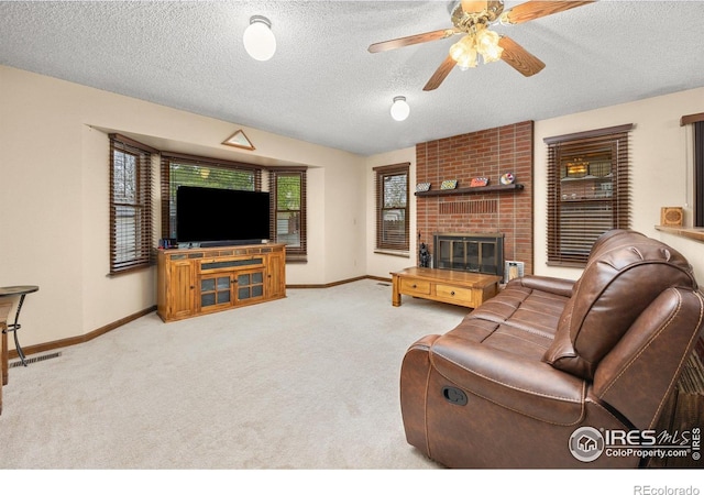 1183 38th Ave, Greeley, CO 80634 - living area featuring a ceiling fan, a textured ceiling, carpet, and a fireplace