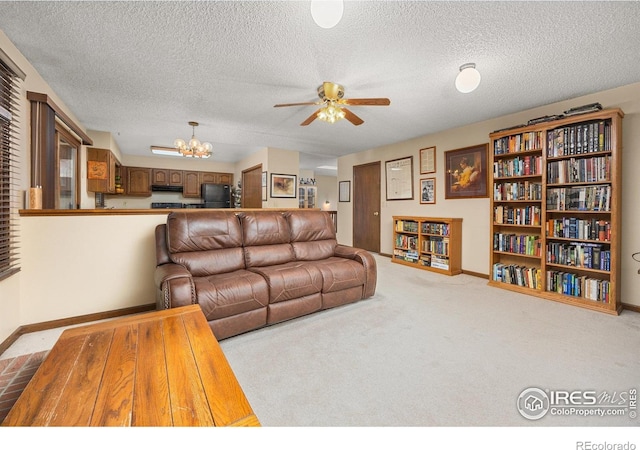 1183 38th Ave, Greeley, CO 80634 - carpeted living area featuring a chandelier, ceiling fan, and a textured ceiling