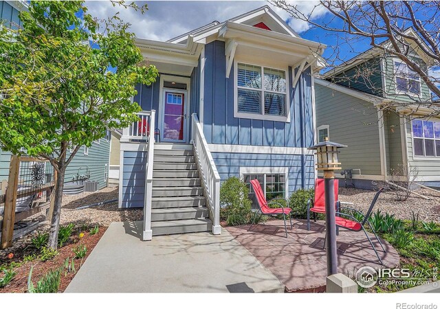 541 Hoyt Ln, Lafayette, CO 80026 - view of front facade featuring board and batten siding, a patio, and cooling unit