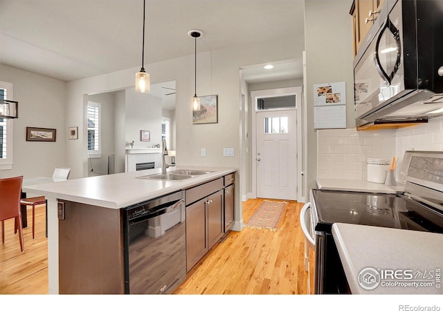 541 Hoyt Ln, Lafayette, CO 80026 - kitchen with black microwave, a sink, dishwasher, light wood-type flooring, and range with electric stovetop