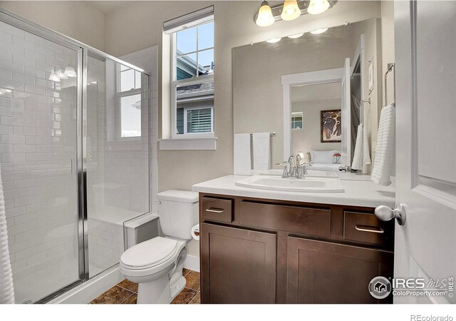 541 Hoyt Ln, Lafayette, CO 80026 - bathroom with vanity, toilet, tile patterned floors, and a stall shower