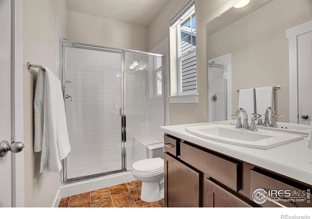 541 Hoyt Ln, Lafayette, CO 80026 - bathroom featuring vanity, a stall shower, and toilet