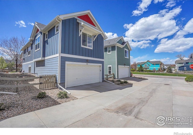 541 Hoyt Ln, Lafayette, CO 80026 - view of home's exterior featuring an attached garage, board and batten siding, fence, and driveway