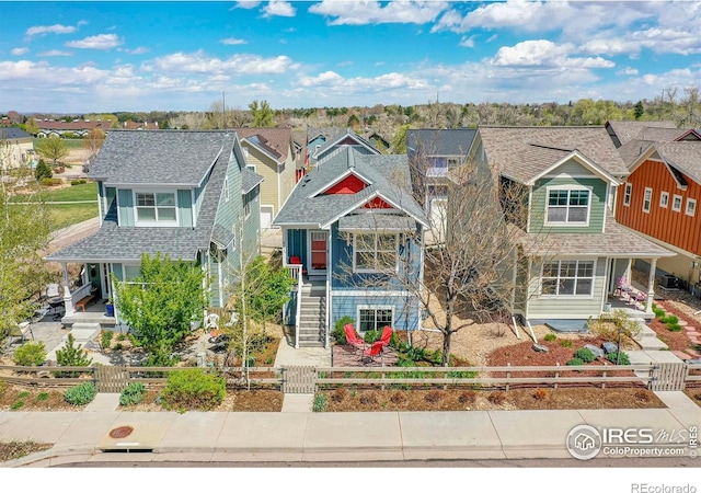 541 Hoyt Ln, Lafayette, CO 80026 - view of front of home with a fenced front yard, a residential view, stairs, and a porch