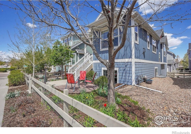 541 Hoyt Ln, Lafayette, CO 80026 - view of property exterior with a patio, stairs, and fence private yard