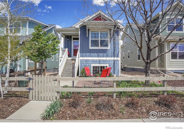 541 Hoyt Ln, Lafayette, CO 80026 - view of front of house with board and batten siding, fence private yard, and a gate