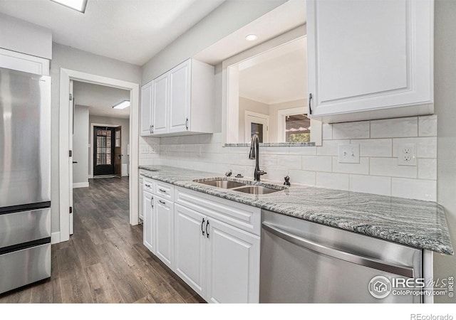 4121 Silene Pl, Loveland, CO 80537 - kitchen featuring decorative backsplash, dark wood-style floors, white cabinets, a sink, and appliances with stainless steel finishes