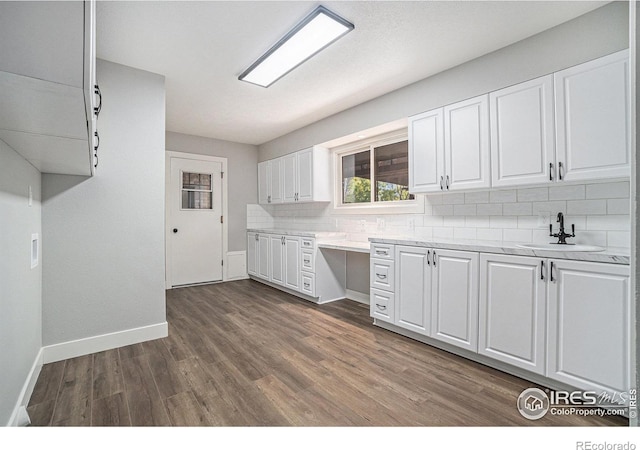 4121 Silene Pl, Loveland, CO 80537 - kitchen with baseboards, light countertops, white cabinets, tasteful backsplash, and a sink