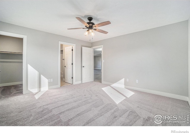 4121 Silene Pl, Loveland, CO 80537 - unfurnished bedroom featuring a walk in closet, baseboards, and carpet floors