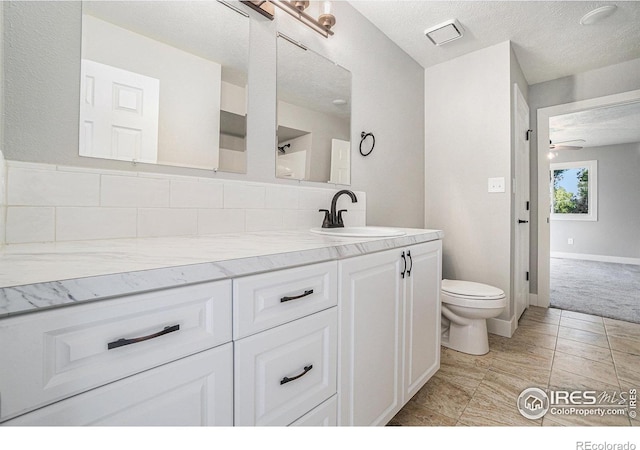 4121 Silene Pl, Loveland, CO 80537 - bathroom with vanity, ceiling fan, toilet, and a textured ceiling