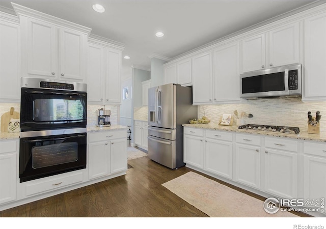 kitchen featuring backsplash, dark wood-style flooring, stainless steel appliances, and white cabinets