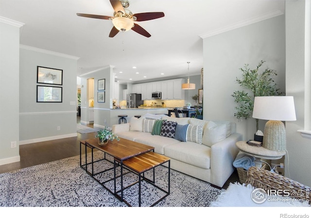 living room featuring wood finished floors, baseboards, ceiling fan, ornamental molding, and recessed lighting