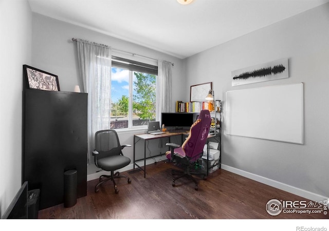 office space with wood finished floors and baseboards
