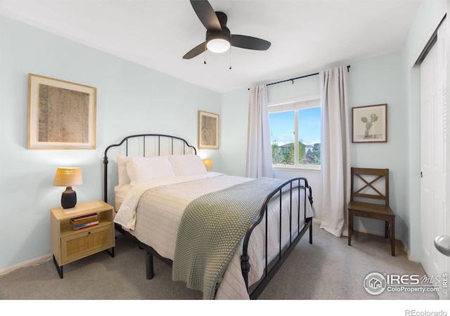 carpeted bedroom featuring baseboards, a closet, and a ceiling fan