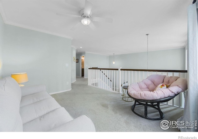 carpeted living area featuring ornamental molding, baseboards, and a ceiling fan