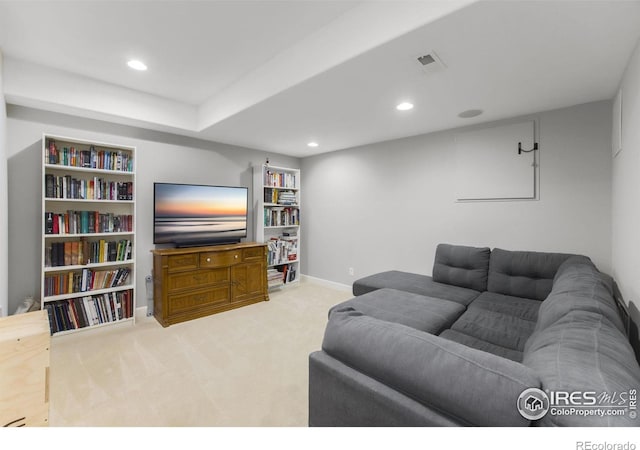 carpeted living area featuring baseboards, recessed lighting, and visible vents