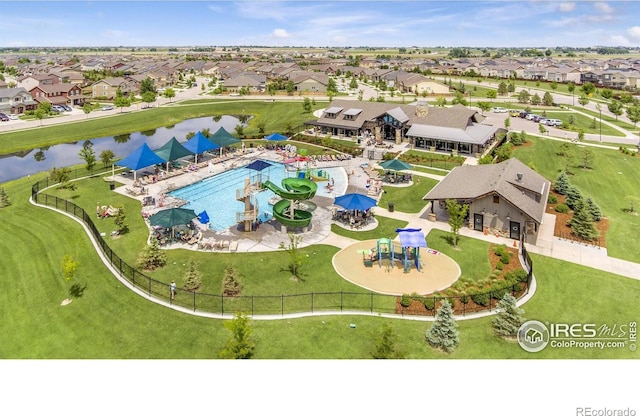 drone / aerial view with a water view and a residential view