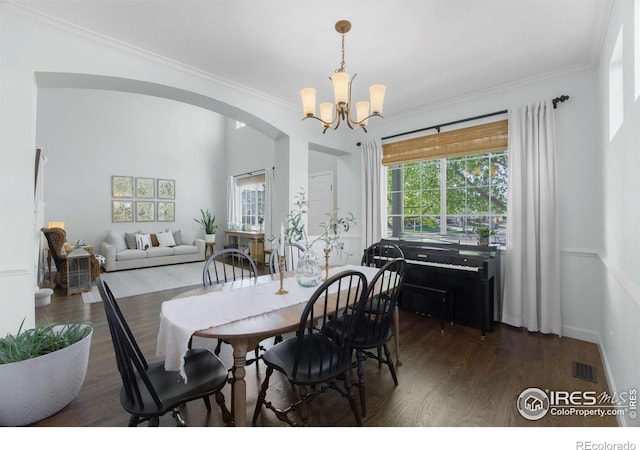6386 Mayfair Ave, Timnath, CO 80547 - dining area with arched walkways, wood finished floors, plenty of natural light, a chandelier, and crown molding