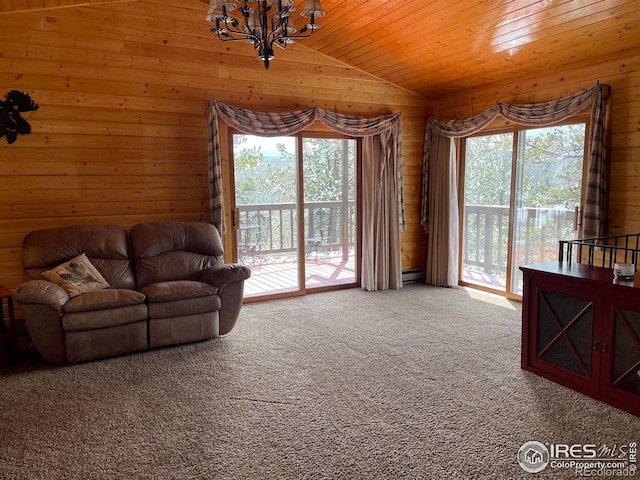 134 Swift Deer Rd, Red Feather Lakes, CO 80545 - carpeted living area featuring vaulted ceiling, a chandelier, wood walls, baseboard heating, and wood ceiling