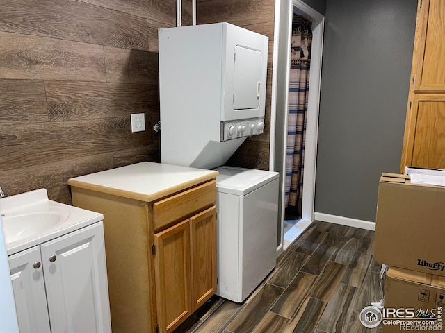 134 Swift Deer Rd, Red Feather Lakes, CO 80545 - washroom with stacked washing machine and dryer, wood tiled floors, and baseboards