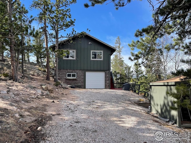 134 Swift Deer Rd, Red Feather Lakes, CO 80545 - view of side of property featuring a garage, driveway, and board and batten siding